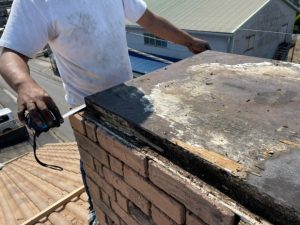 煙突の板金補修作業する風景